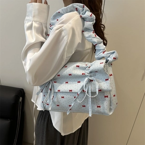 Light blue shoulder bag with red bow prints and ruffled cloud-style handle for women