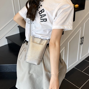 Minimalist silver pebbled leather bucket phone bag with crossbody strap for women