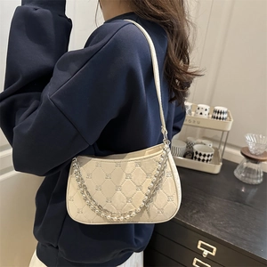 Elegant cream shoulder bag with quilted embroidery and pearl chain decoration