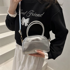 Metallic silver leather handbag with dual top handles and detachable shoulder strap