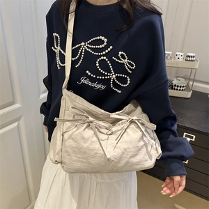 Minimalist beige large capacity crossbody bag with decorative side bows and wide strap