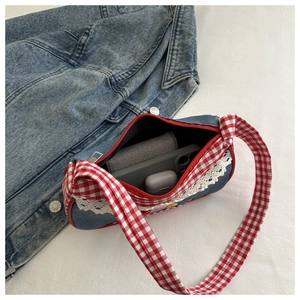 Detail of cute plaid denim shoulder bag showing interior capacity and lace trim details
