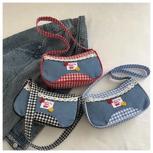 Close-up of cute plaid tote bags with lace trim and cherry patches in three colors
