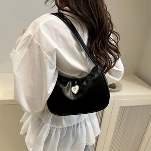 Elegant black leather hobo bag with a pearl-trimmed heart and golden bow detail