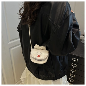 Mini white crossbody bag for girls featuring a 3D bow and cute puppy illustration