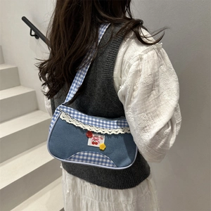 Plaid canvas shoulder bag with blue denim stitching and cherry lace decorations