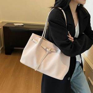 Minimalist beige woven tote bag for women shown with a stylish casual outfit