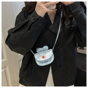 Detailed view of light blue checkered mini bag featuring cute dog print and bow accent