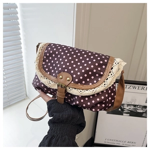Detail of coffee brown polka dot bag with pink dots and beige lace trim details