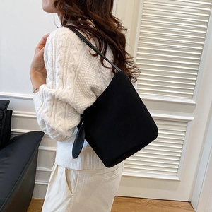 Minimalist black faux suede tote bag shown on model with chic Korean style outfit