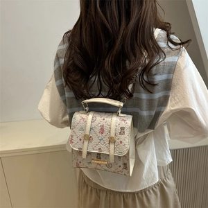 Chic beige college style backpack with cute cartoon animal prints shown on a model back