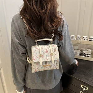 Sweet cream-colored backpack with pink cartoon bears and strawberries on model