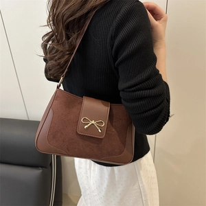 Minimalist brown crossbody shoulder bag with golden bow buckle on suede leather mix