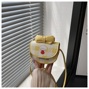 Close-up of a yellow checkered mini crossbody bag with a bow and cute puppy print