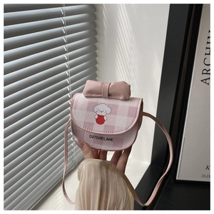 Detailed close-up of a pink checkered mini crossbody bag with a cute puppy print and bow