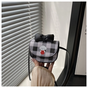 Detailed view of mini crossbody bag with gingham pattern, black bow and cartoon dog print