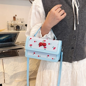 Light blue square handbag with red cherry patterns and charms, crossbody summer style
