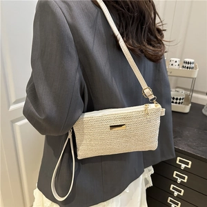 Chic cream straw woven crossbody bag with metallic logo and detachable leather strap