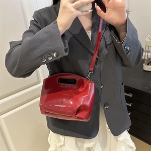 Red patent leather handbag with chain strap and Fashion & Bags text on model