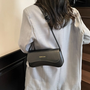 Minimalist black faux leather shoulder baguette bag with gold print for women