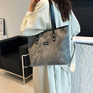 Minimalist grey marble pattern tote bag with black handles and fashion label for women