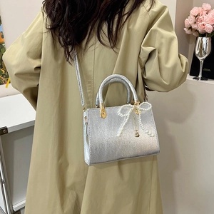 Silver metallic small square handbag with pearl bow charm and top handle for women