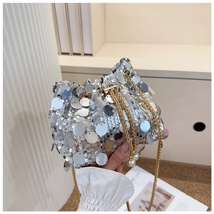 Detail of silver sequin bucket bag with gold chain drawstring and pearl accents