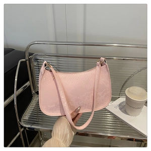 Detail of pink snake pattern faux leather shoulder bag with golden metal hardware