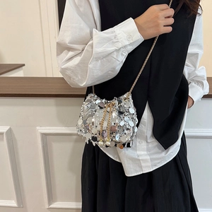 Chic silver sequin bucket bag with gold chain strap and elegant pearl drawstring charms