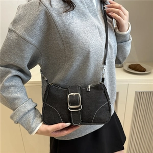Retro black denim shoulder bag with white contrast stitching and silver buckle detail