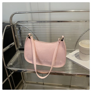 Detail of light pink faux snake skin texture on minimalist half moon underarm bag