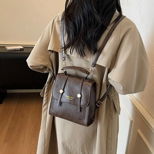 Vintage dark brown faux leather backpack for women with gold buckles and adjustable straps