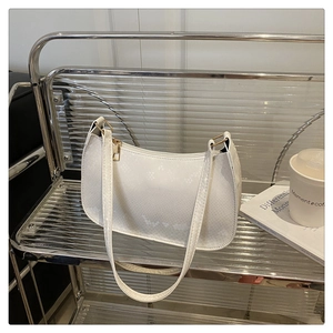 Detailed macro view of the cream white faux leather bag with elegant snake skin embossing