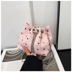 Pink drawstring bucket bag with floral jacquard texture and elegant pearl chain strap
