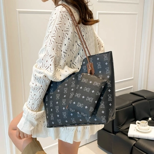 Retro black tote bag with cartoon bear pattern and matching inner pouch on a model