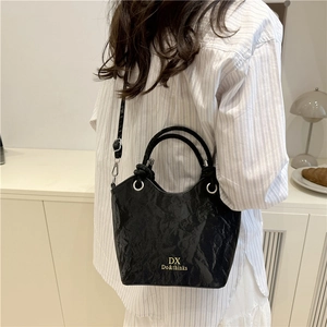 Chic black wrinkled texture bucket bag for women with gold logo and crossbody strap
