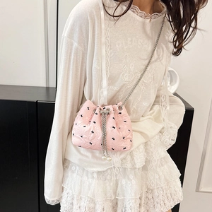 Pink mini bucket bag with black rabbit pattern and pearl charm on a chain strap