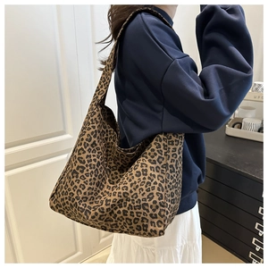 Side view of leopard print tote bag on shoulder showing large capacity and soft canvas