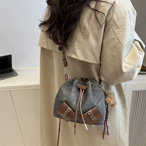 Chic canvas bucket bag with drawstring closure and brown leather details for women