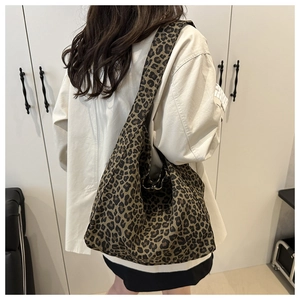 Detail of the leopard print canvas tote bag showing the thick texture and hobo style