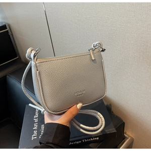 Close-up of silver lychee texture crossbody bag with zipper and slim shoulder strap