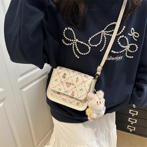 White minimalist square crossbody bag with floral bear pattern and plush rabbit pendant