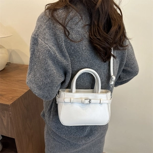 Minimalist cream white crossbody bag with decorative buckle and slim shoulder strap