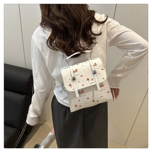 Vue arrière du mannequin portant un mini sac à dos blanc avec chiots et cerises cartoon