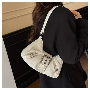 Detail of white patent leather shoulder bag with decorative metal buckles and pleats