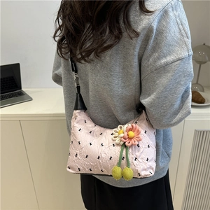 Pink pleated underarm bag with black K print and decorative knit flower charm