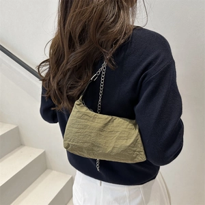Chic army green pleated underarm bag with silver chain strap worn on the shoulder
