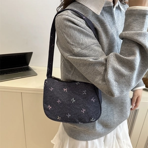 Blue denim underarm bag with butterfly embroidery and minimalist shoulder strap design
