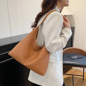 Deep brown woven leather hobo bag with large capacity shown in a vintage home setting