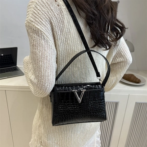Chic black crocodile embossed leather handbag with silver V-shaped metal hardware